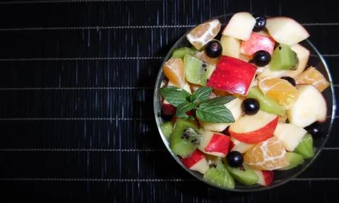 Fruit salad on a dark background Stock Photos