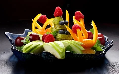 Fruit salad on a dark background. Stock Photos