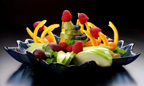 Fruit salad on a dark background. Stock Photos