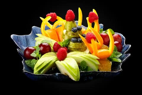 Fruit salad on a dark background. Stock Photos