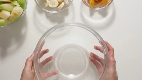 Fruit salad. Melon, banana, mango slices close up in a glass bowl.  Stock Footage 136718136