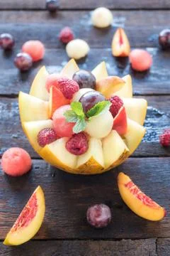 Fruit salad in melon Stock Photos