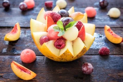 Fruit salad in melon Stock Photos