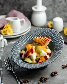 Fruit salad in a plate on the table Stock Photos
