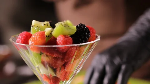 Fruit salad with strawberry, kiwi, raspberry, blackberry, honey, whipped cream Stock Footage 127855367