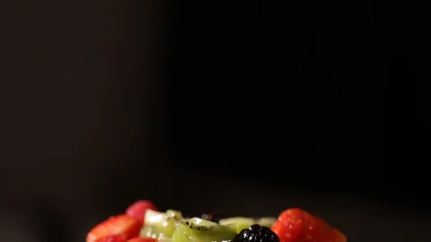 Fruit salad with strawberry, kiwi, raspberry, blackberry, honey, whipped cream Stock Footage 127855381