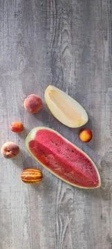 Fruit set on the table made of a quarter of watermelon, melon, peaches Stock Photos
