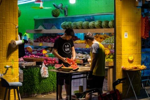 Fruit shop in China with client and seller Stock Photos