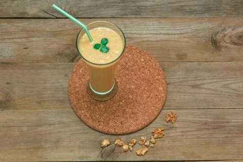 Fruit smoothie with a straw on a stand Stockfoto's