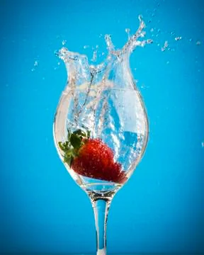 Fruit splashes in wine glasses Stock Photos
