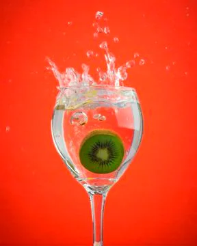 Fruit splashes in wine glasses Stock Photos
