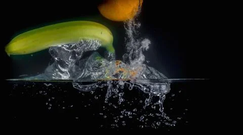 Fruit Splashing into water. Stock Photos