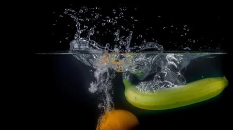 Fruit Splashing into water. Stock Photos