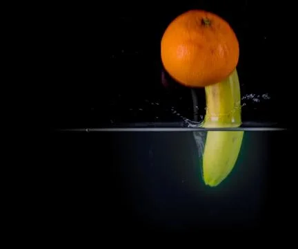 Fruit Splashing into water. Stock Photos