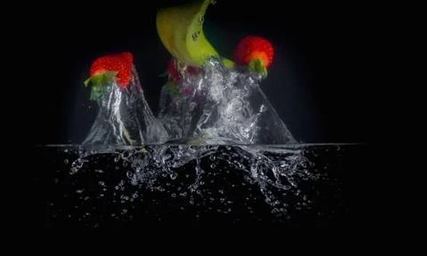 Fruit Splashing into water. Stock Photos