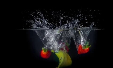 Fruit Splashing into water. Stock Photos