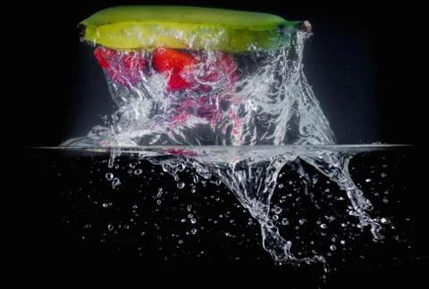 Fruit Splashing into water. Stock Photos