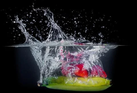 Fruit Splashing into water. Stock Photos