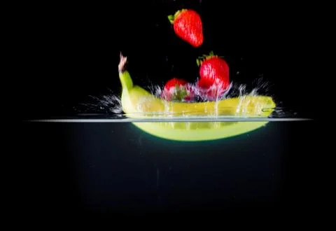 Fruit Splashing into water. Stock Photos