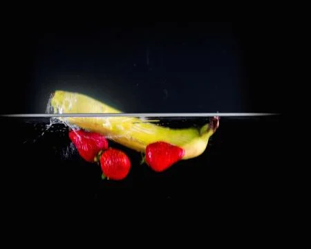 Fruit Splashing into water. Stock Photos
