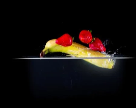 Fruit Splashing into water. Stock Photos