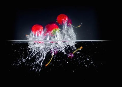 Fruit Splashing into water. Stock Photos