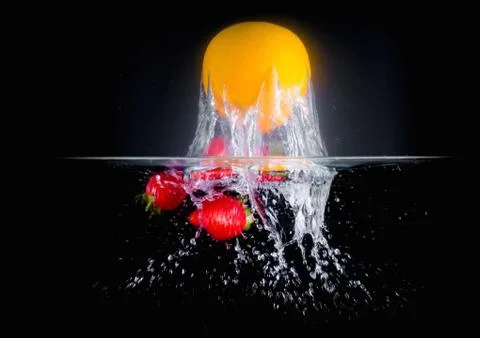 Fruit Splashing into water. Stock Photos