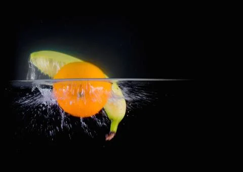 Fruit Splashing into water. Stock Photos