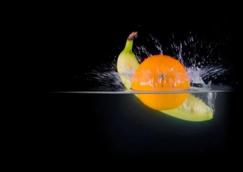 Fruit Splashing into water. Stock Photos