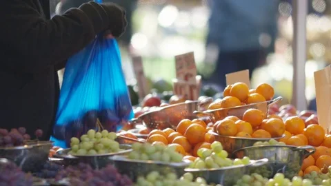 Fruit stall trader bagging up fruit for customer Video stock 85281197