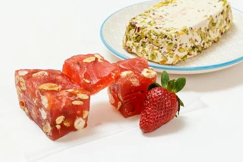 Fruit sweets with nuts and halva on white background. Stock Photos