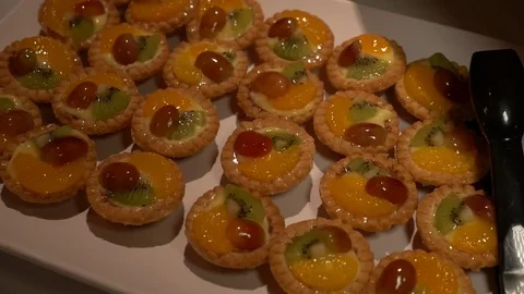 Fruit tarts on a white plate. Video stock 74288048