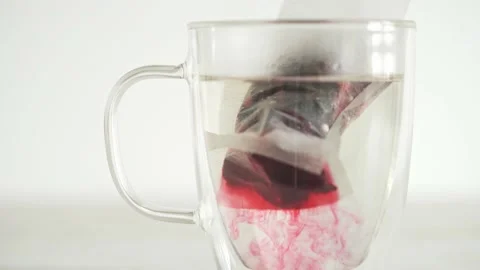 Fruit tea bag. Double walled clear glass cup. Hibiscus tea in a transparent Stock Footage 155359981