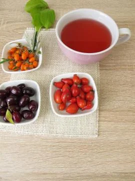 Fruit tea with cornelian cherry, rose hip and sea buckthorn Stock Photos
