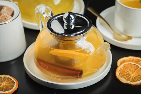 Fruit tea with mango and mint in a glass teapot on the table Stock Photos