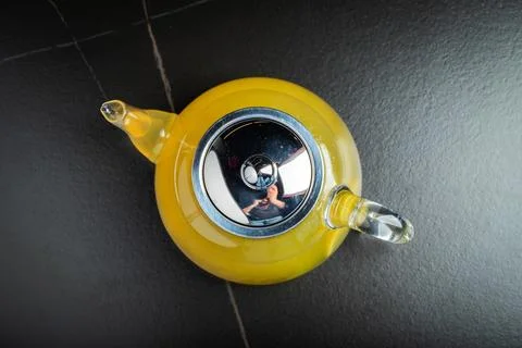 Fruit tea with mango and mint in a glass teapot on the table Stock Photos