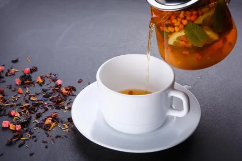 Fruit tea with slice of lemon. Mixture herbal floral fruit tea with petals, dry Stock Photos