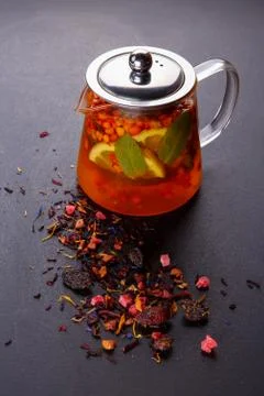 Fruit tea with slice of lemon. Mixture herbal floral fruit tea with petals, dry Stock Photos