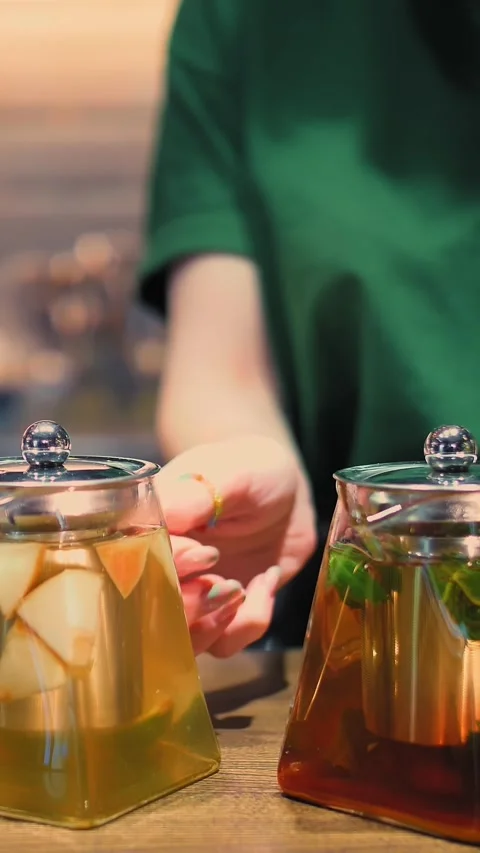Fruit tea in a teapot. herbal tea. tea drink. close-up. barmen put on the table Stock Footage 323513813