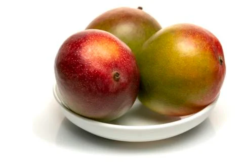 Fruit three mango fruit in a plate isolated on white background Stock Photos