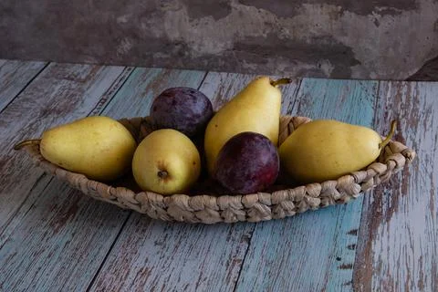 Fruit trees on a wicker plate in the form of a boat, which stands on boards i Stock Photos