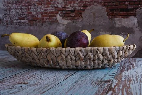 Fruit trees on a wicker plate in the form of a boat, which stands on boards i Fotos Stock