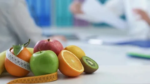 Fruit vitamin on worktable. Close up doctor writing notes Stock-Footage 336588324