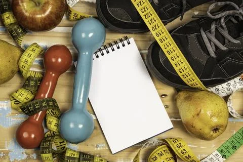 Fruit for weight loss with measuring tape and equipment for exercise and di.. Stock Photos