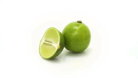 Fruit whole and slice Lime Spinning and Rotating Isolated on White Background Stock Footage 222938991