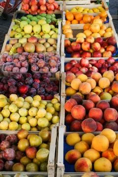 Fruit in wooden boxes Stock Photos