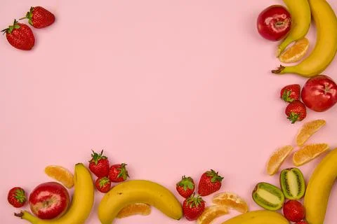 Fruits and berries on a light background with a place to insert Stock Photos