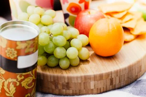 Fruits and biscuits in picnic setting Stock Photos