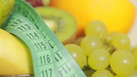 Fruits and measuring tape close up. The concept of diet Stock Footage 72169363