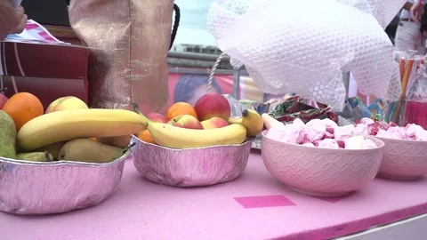 Fruits and snacks on pink table slidershot Stock Footage 78573249